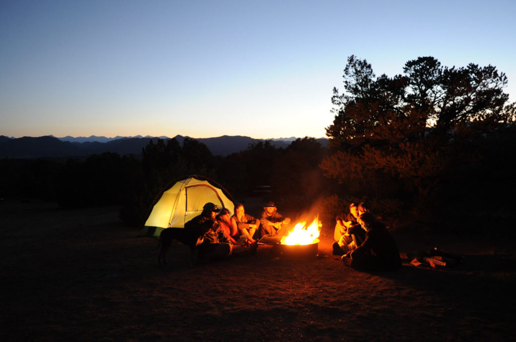 camping in Colorado with campfire at dusk