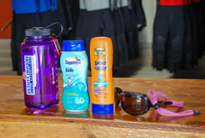 water bottle, sunscreen, and sunglasses